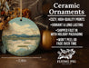 a ceramic ornament with a painting of a lake