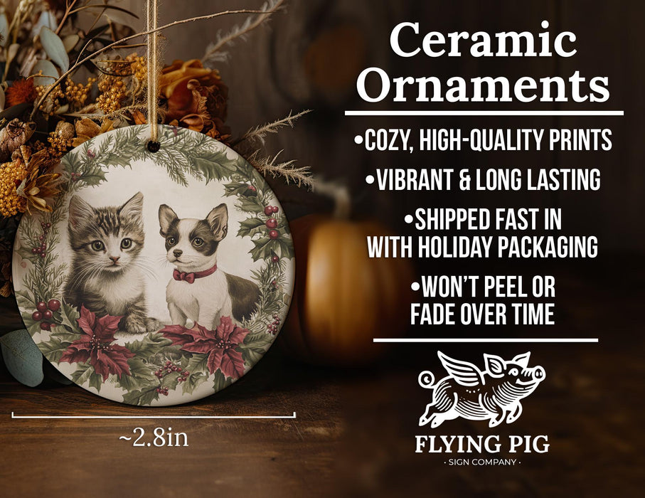 a ceramic ornament with two cats on it