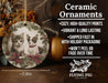 a ceramic ornament with two cats on it