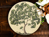 a plate with a tree painted on it next to flowers