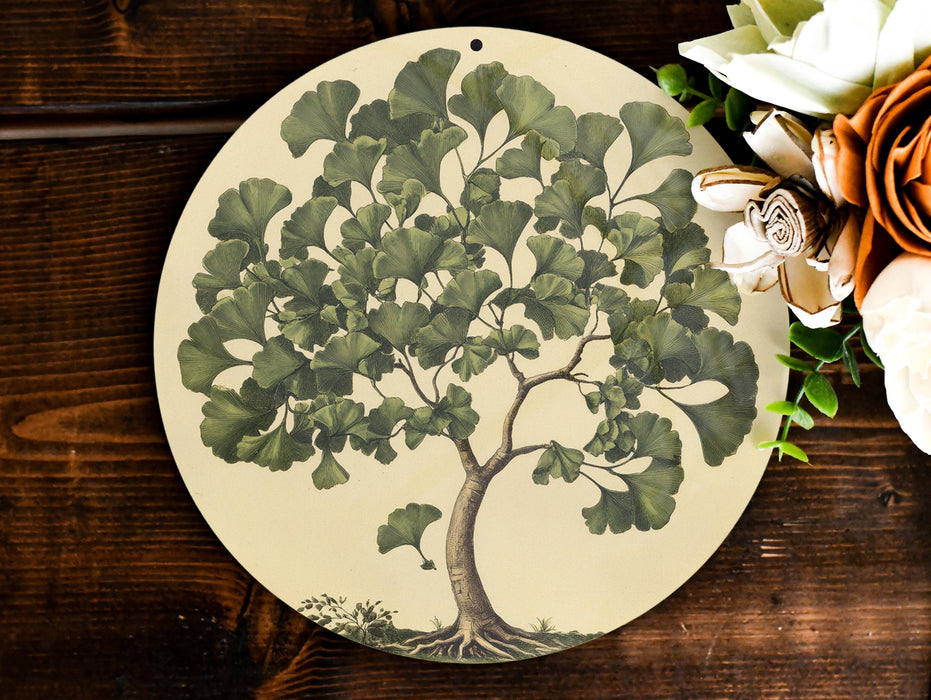 a plate with a tree painted on it next to flowers