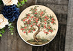 a plate with an apple tree painted on it
