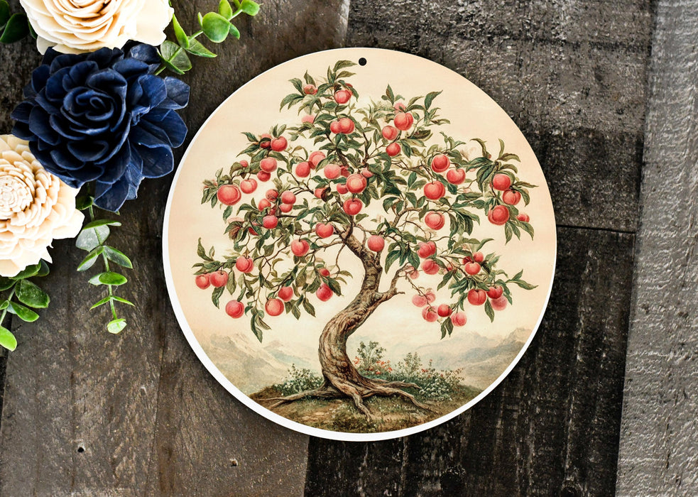 a plate with an apple tree painted on it