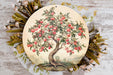 a plate with a painting of an apple tree on it