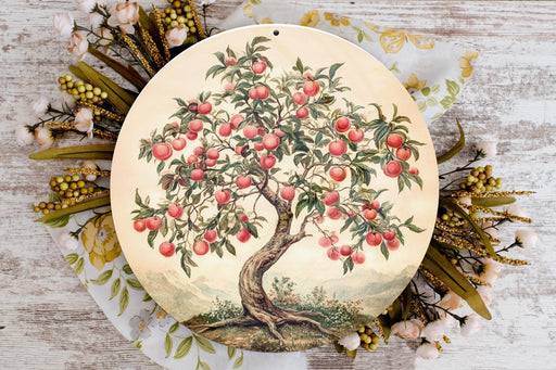a plate with a painting of an apple tree on it