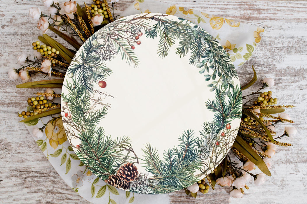 a white plate with a green and red wreath on it