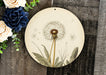 a clock with a dandelion painted on it