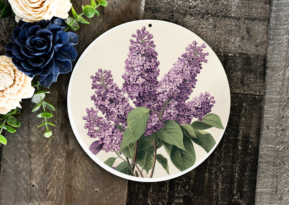 a plate with purple flowers on it next to a bouquet of flowers
