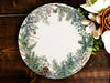 a white and green plate with a pine cone on it