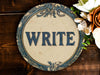 a sign that says write on it next to flowers
