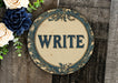 a sign that says write on it next to flowers