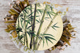a plate with a painting of a bamboo tree on it