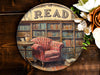 a picture of a red chair in front of a bookshelf