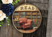 a picture of a red chair in front of a bookshelf