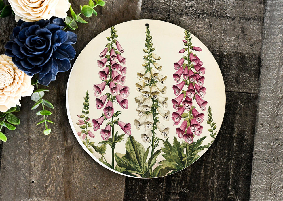 a plate with flowers painted on it next to a bouquet of flowers