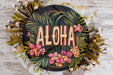 a sign that says aloha surrounded by flowers