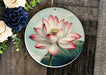 a plate with a picture of a flower on it