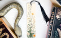 a bookmark with a snake and flowers on it