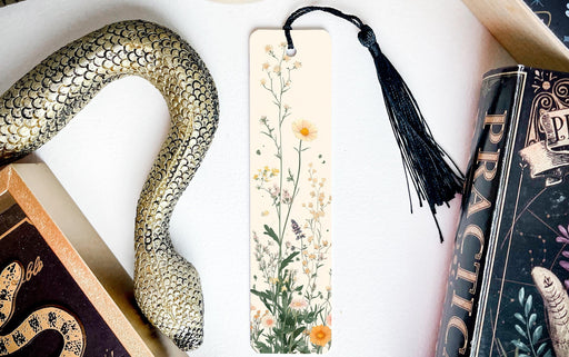 a bookmark with a snake and flowers on it