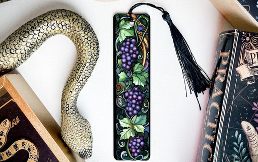 a bookmark with grapes and a snake on it
