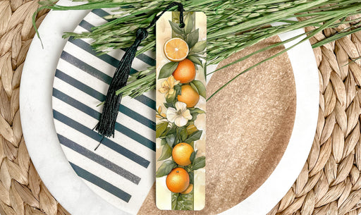 a white plate topped with oranges and green leaves