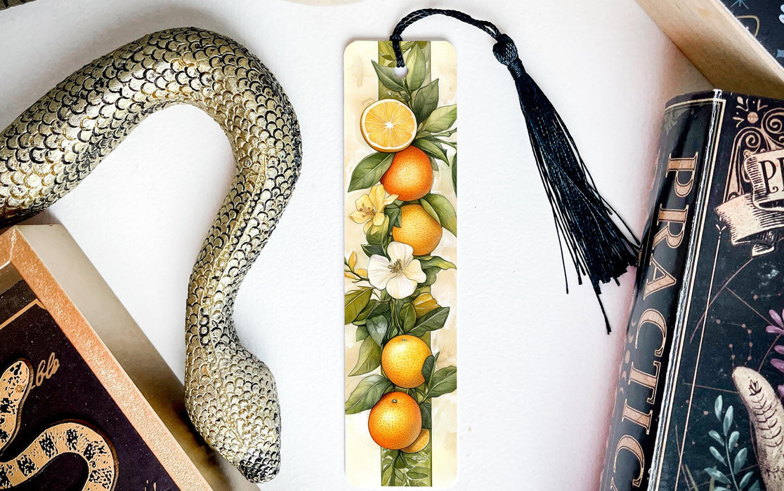 a bookmark with oranges and a snake on it