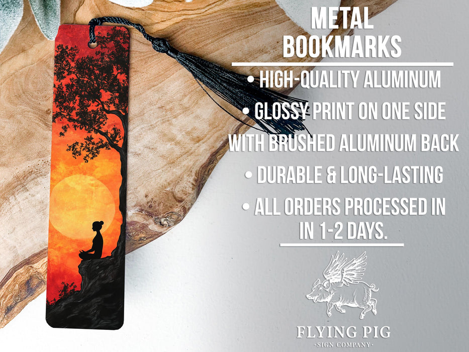 a bookmark with a picture of a boy sitting on a tree