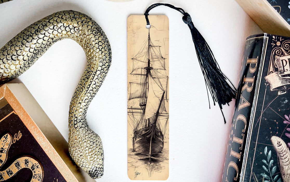 a snake, a bookmark, and some books on a table