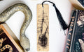 a snake, a bookmark, and some books on a table
