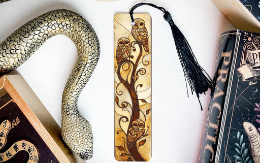 a bookmark, snake, and other books on a table