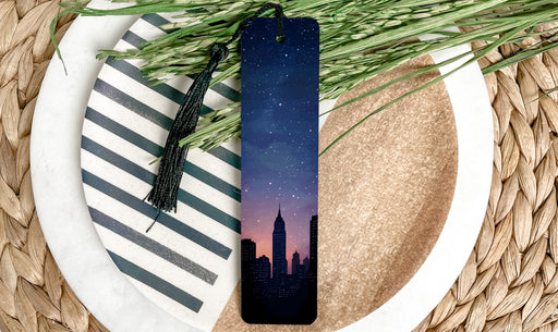 a bookmark sitting on top of a plate next to a plant