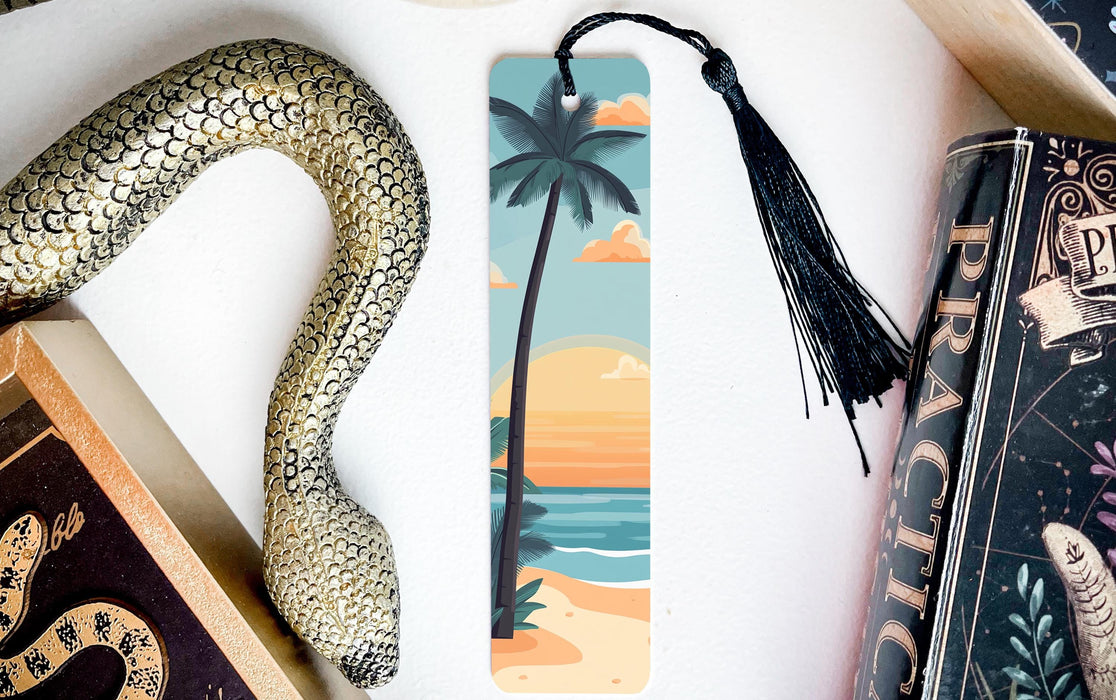 a bookmark with a snake on it next to a book