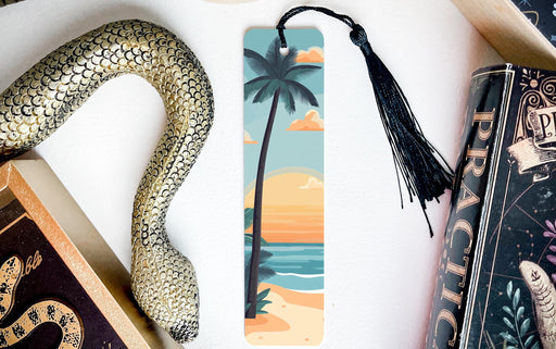 a bookmark with a snake on it next to a book