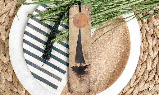 a white plate topped with a green plant next to a knife