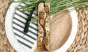 a wooden bookmark sitting on top of a plate