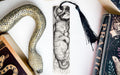 a bookmark with a picture of a cat and a snake on it