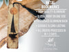 a wooden plaque with a tassel hanging from it