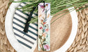a close up of a plate with a bookmark