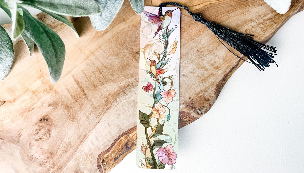 a bookmark with a tassel on top of a piece of wood