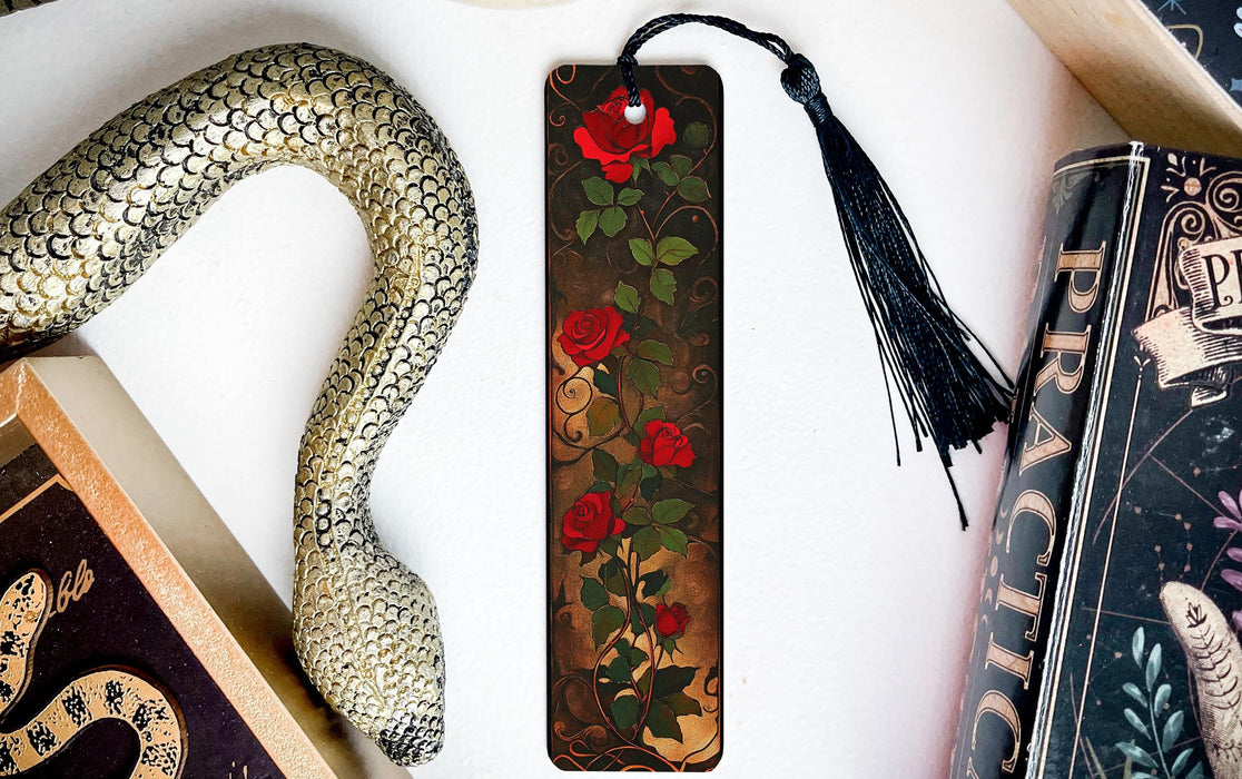 a bookmark with a snake and roses on it
