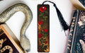 a bookmark with a snake and roses on it
