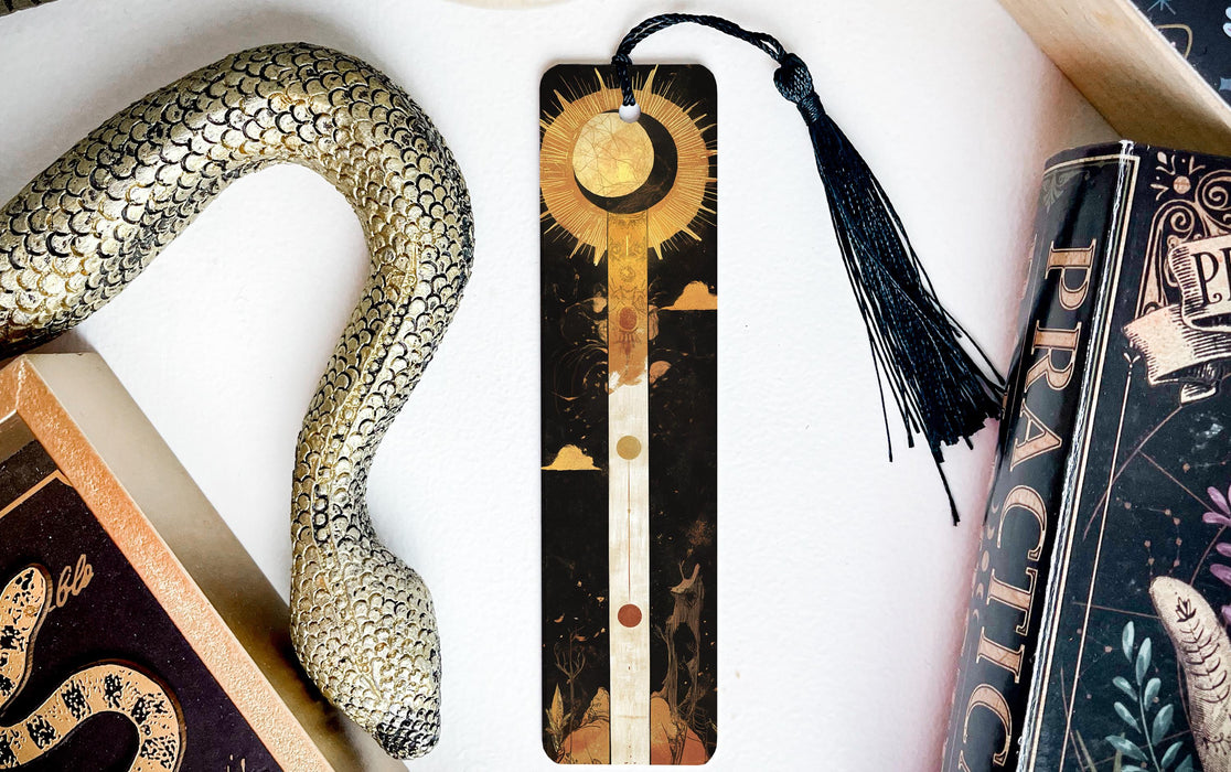 a bookmark with a snake and a book on it