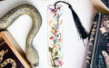 a snake, a bookmark, and some books on a table
