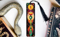 a bookmark with a snake and a book on it