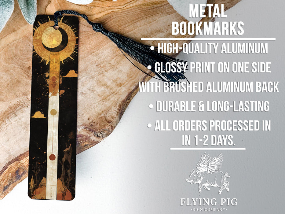 a metal bookmark with a tassel hanging from it
