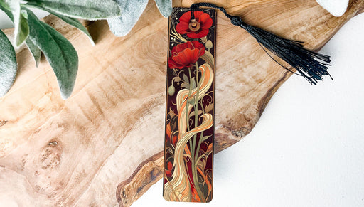 a bookmark with a red flower and a black tassel