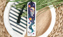 a bookmark with an astronaut on it sitting on a plate