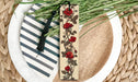 a bookmark with flowers on it sitting on a plate