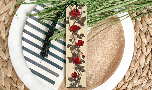 a bookmark with flowers on it sitting on a plate
