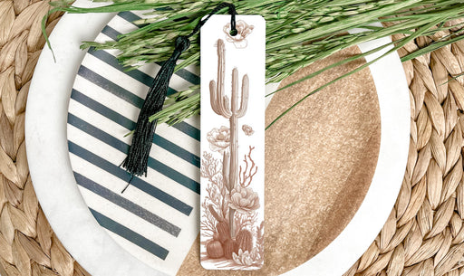 a white plate topped with a green plant next to a tag